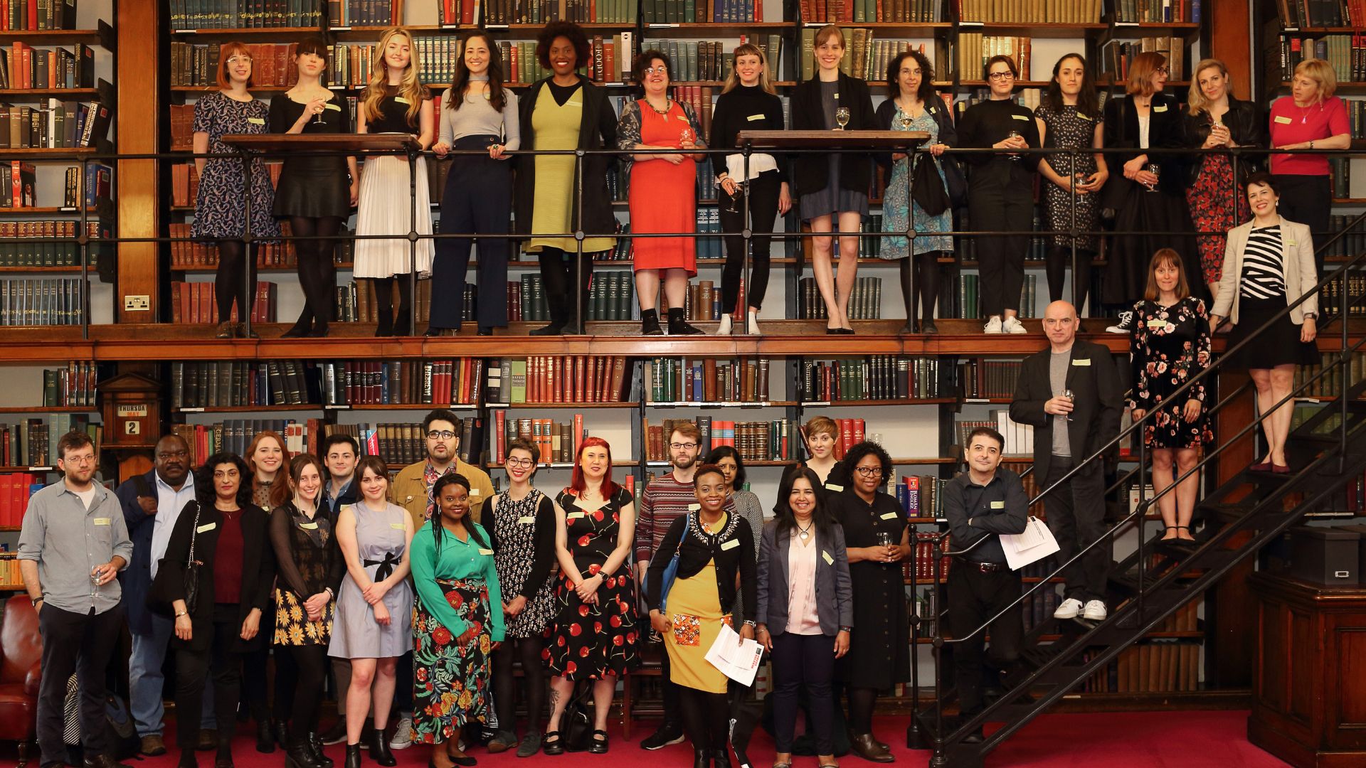 Group of people from the Emerging Writers Programme gathered in the library