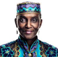 Portrait of Anni, a black woman in brightly coloured coat and hat, against a white background. 