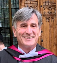Portrait of Paul, a white man in academic ecclesiastical dress.