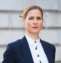 Portrait of Stephanie, a white woman with blonde hair in white shirt and suit jacket. 