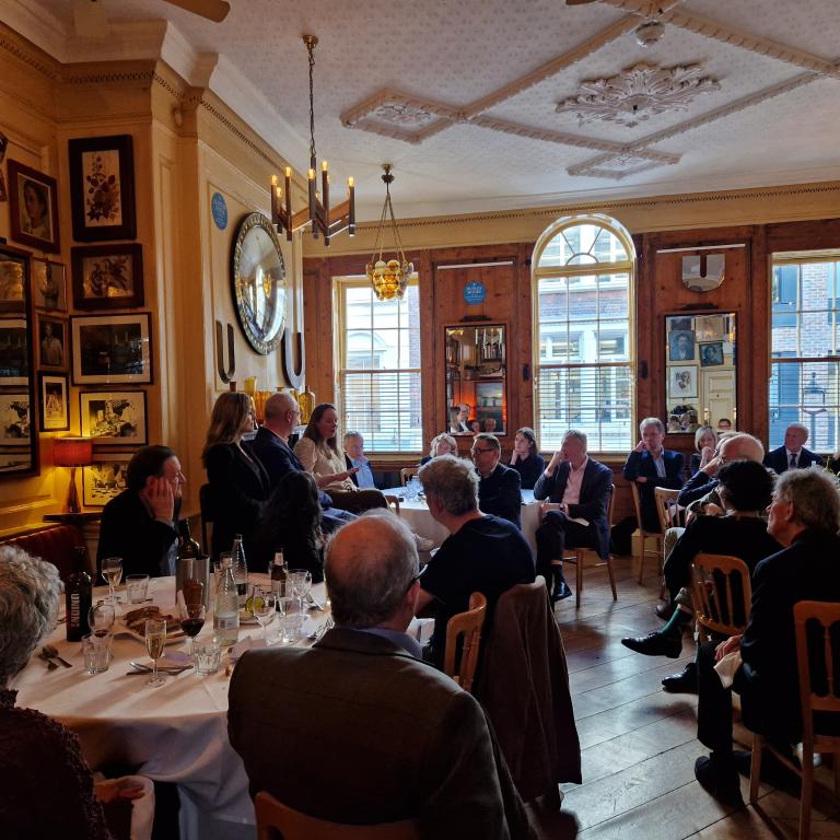 People sat around tables at a supporters lunch