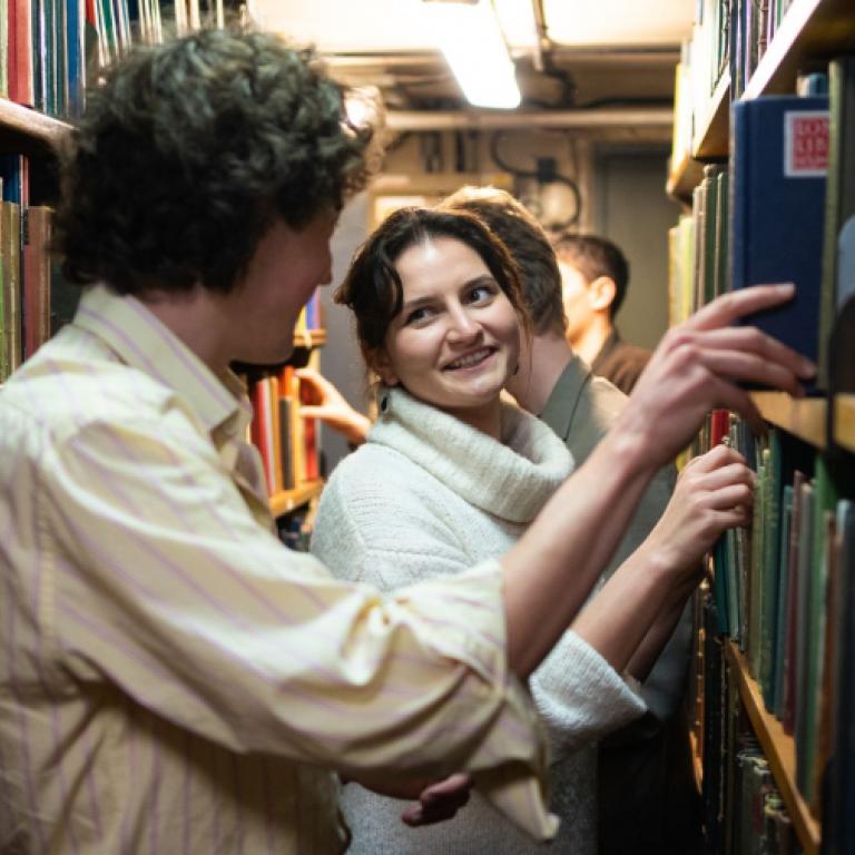 People exploring shelves in a public tour of the London Library
