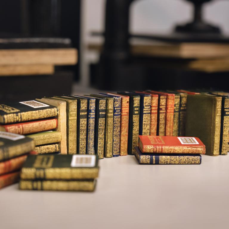 stack of colourful miniature books on table