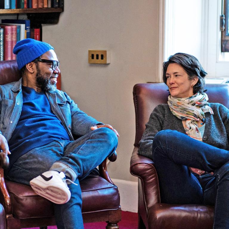 Library users on Reading Room armchairs