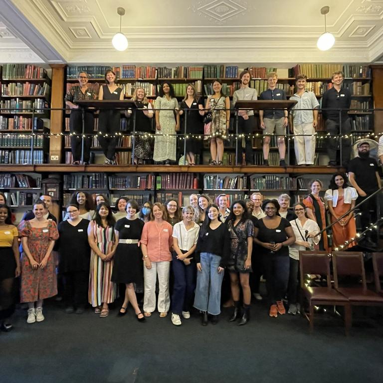 The 2025/26 Emerging Writers cohort gathered for a group photograph on the Library's bookstack gallery.