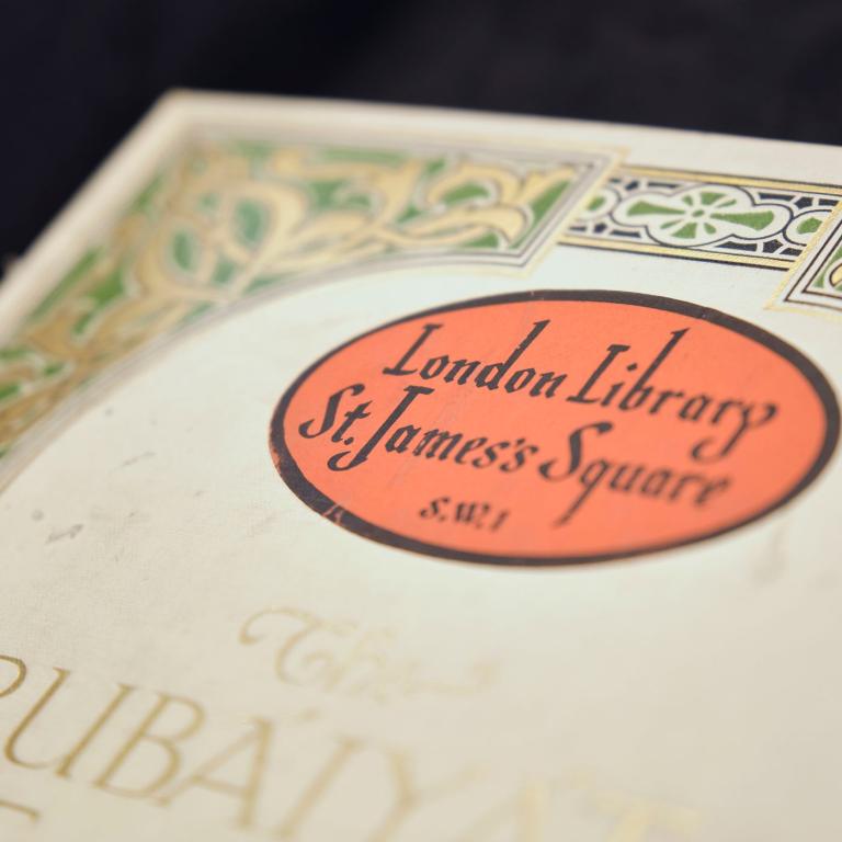A red oval London Library bookplate on the decorated endpaper of an illuminated binding.