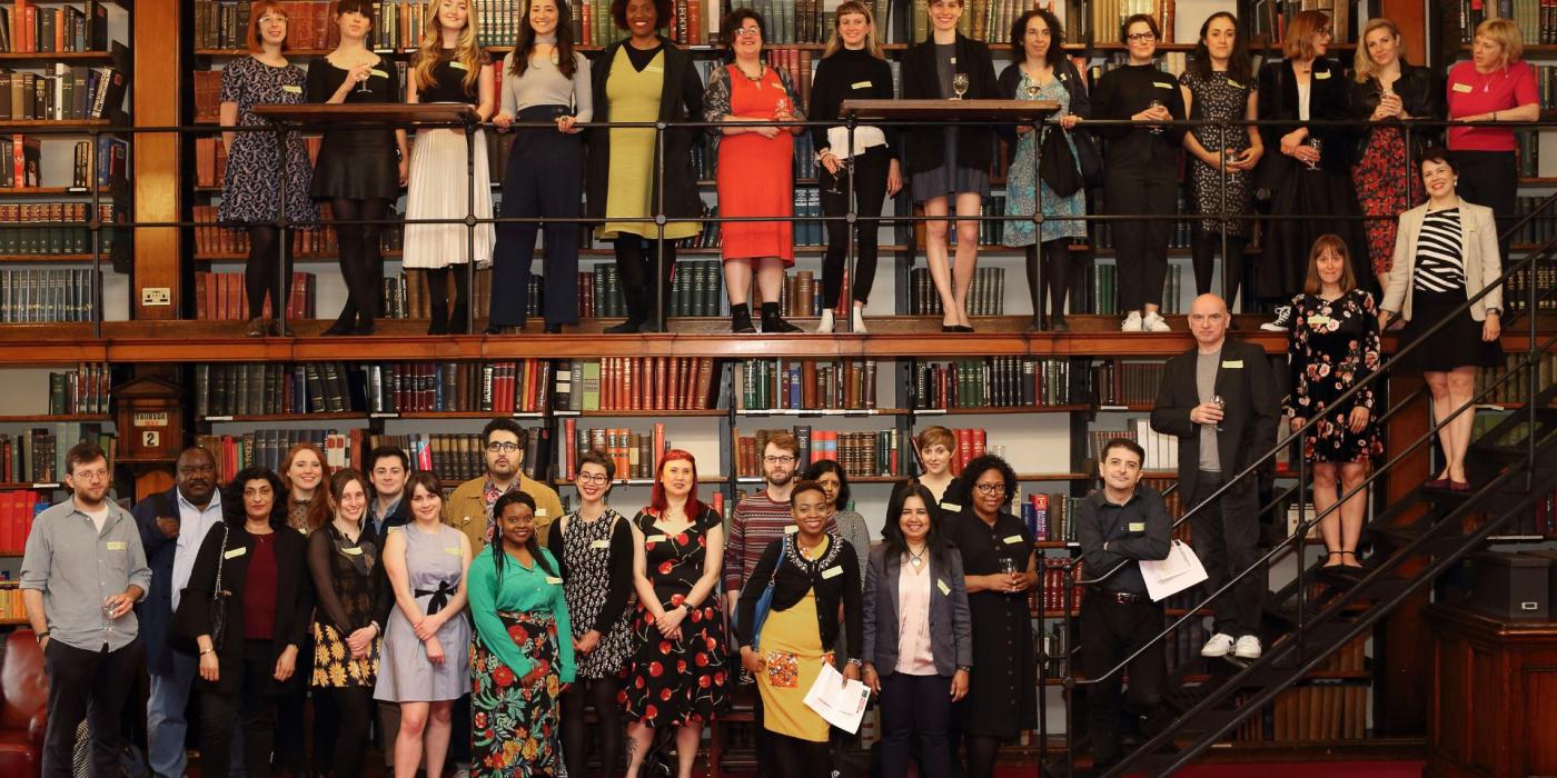 Group of people from the Emerging Writers Programme gathered in the library