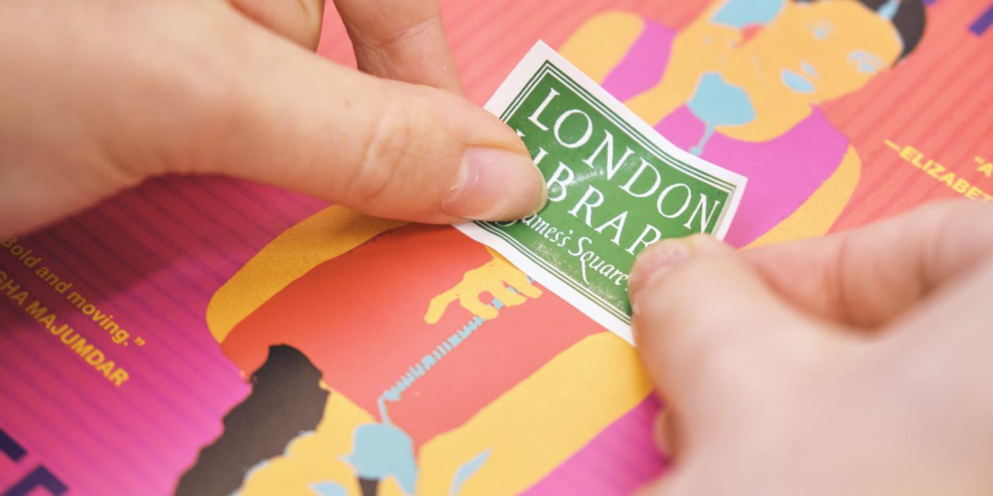 Placing London Library label on book