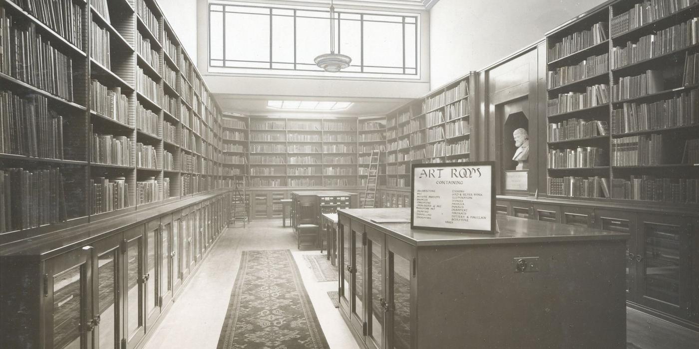 A historic view of the Art Room, its walls lined floor to ceiling with books beneath a skylight.