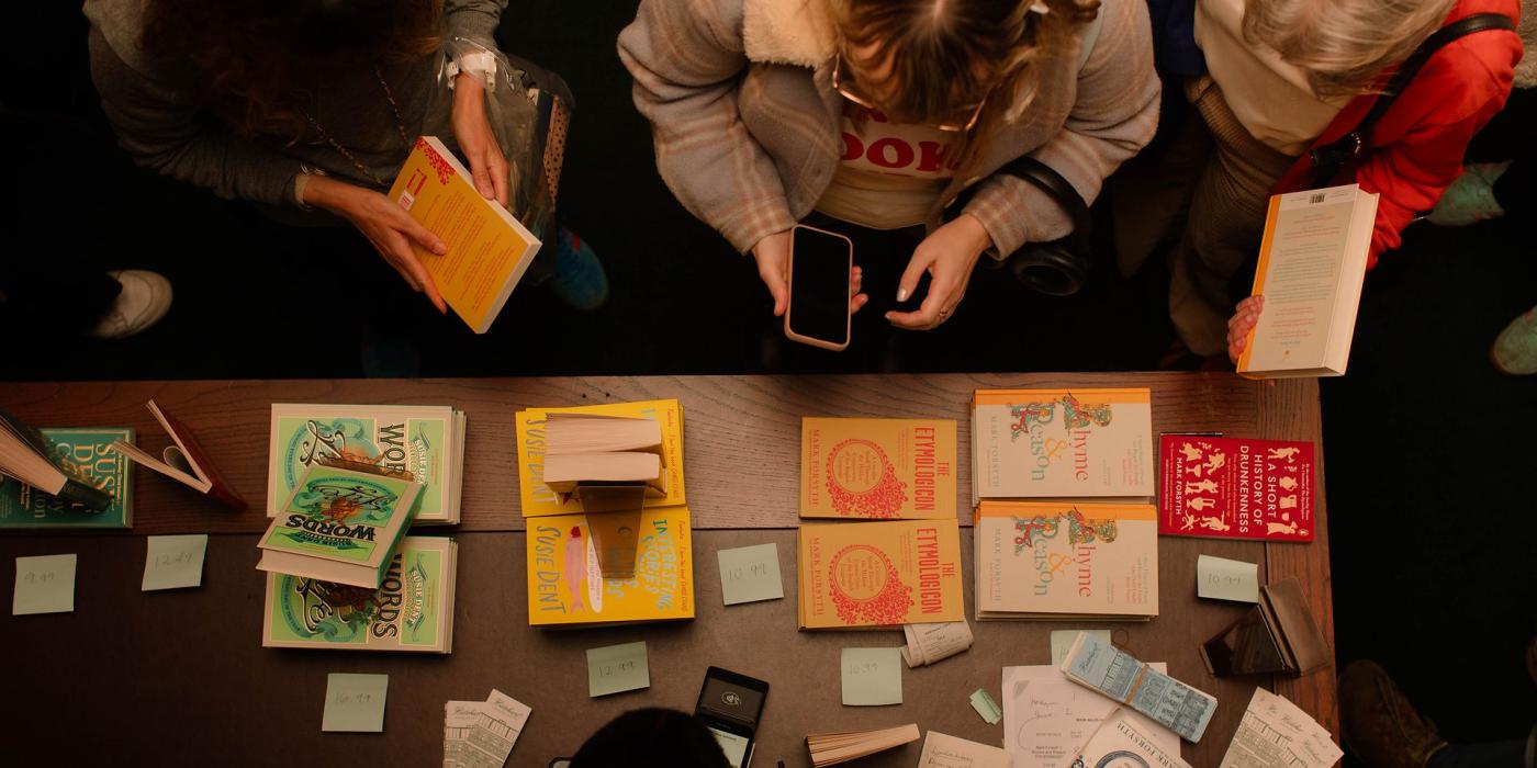 An overhead view of the book stall, its table spread with copies of "The Etymologicon" and "Words".