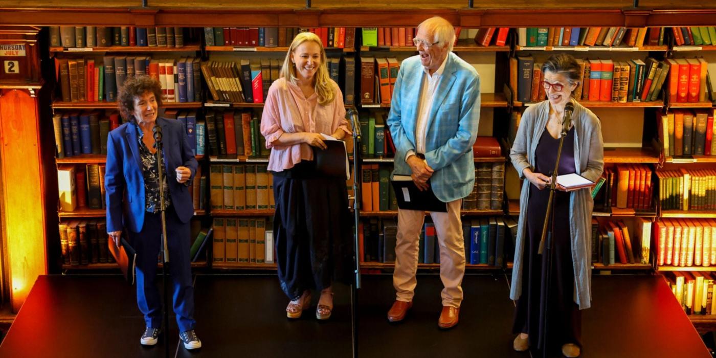People standing and speaking on a stage 